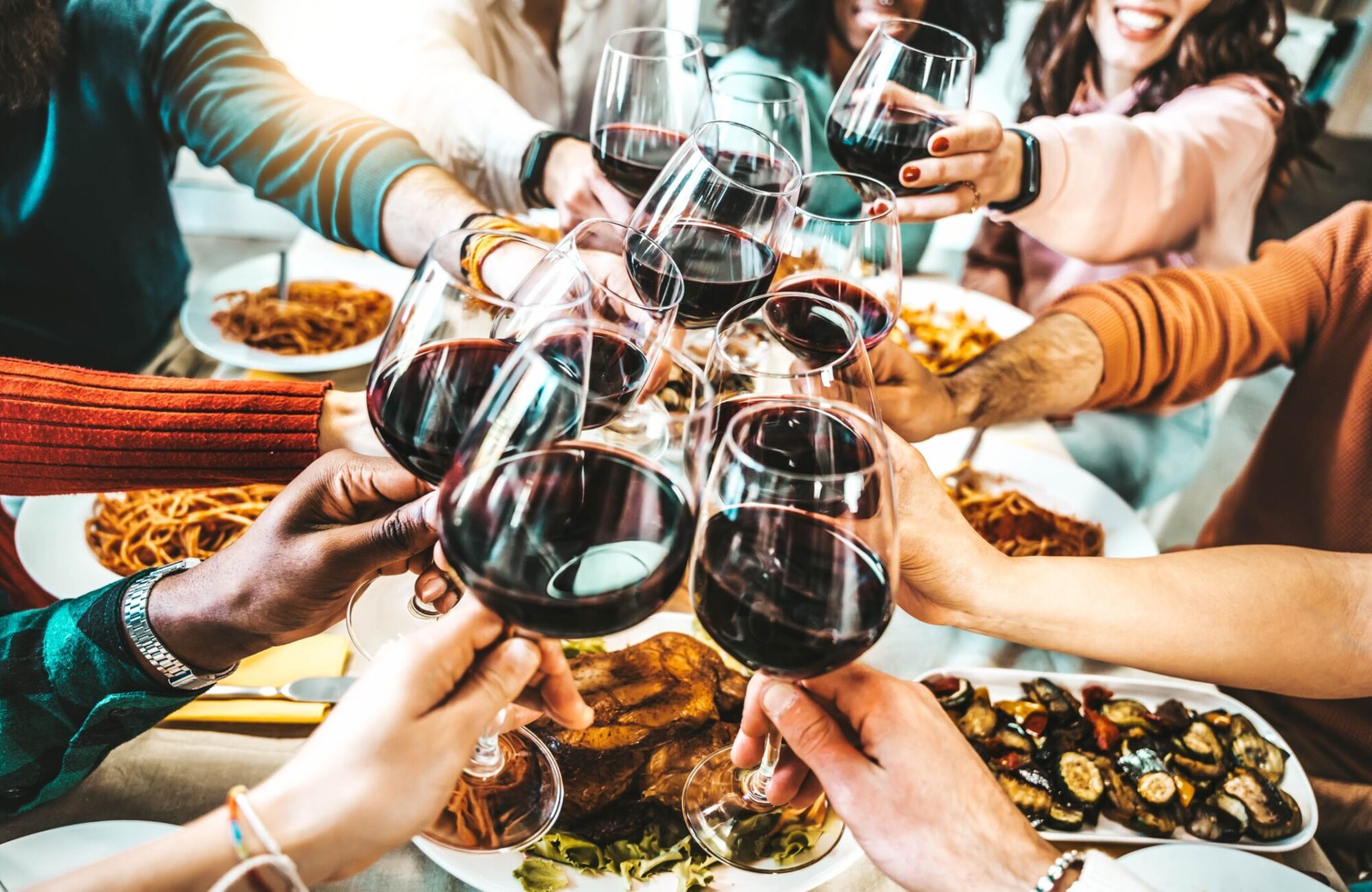 Happy,Friends,Toasting,Red,Wine,Glasses,At,Dinner,Party,-